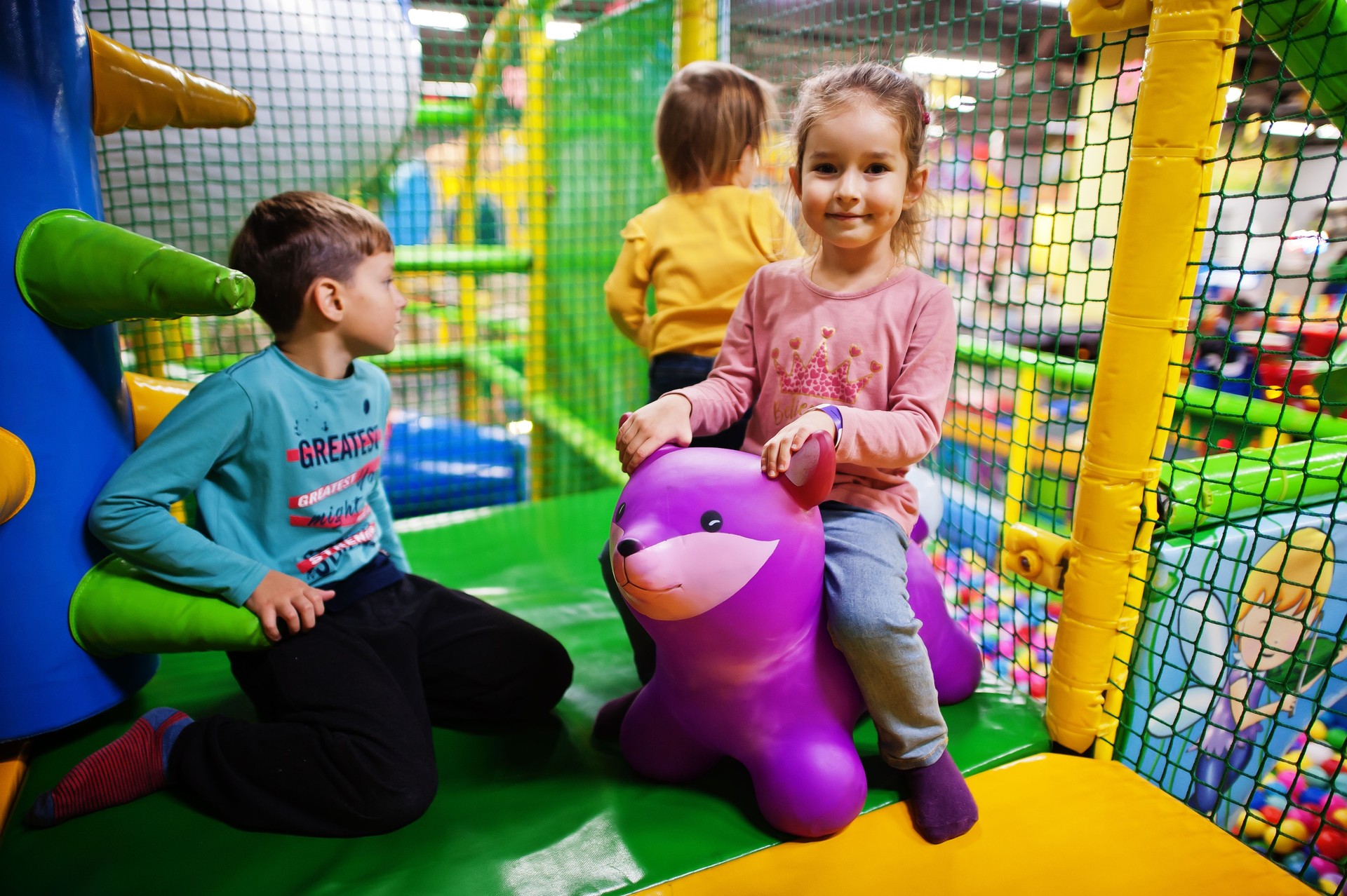 Kids playing in indoor play center. Kindergarten or preschool play room.